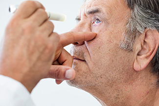 Elderly man examined by an ophthalmologist